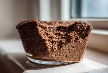 Close-up view showing the airy, rich texture of a serving of chocolate mousse in a glass dish.