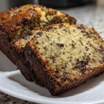 Close-up of sliced chocolate chip vegan banana bread showing a moist crumb and dark crust.