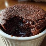 Close-up of a warm, fudgy Cottage Cheese Microwave Brownie with a molten center in a white ramekin.