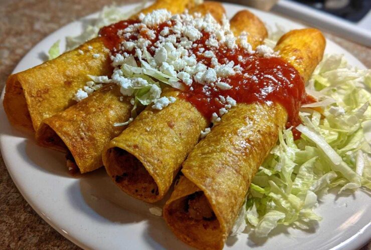 Four crispy, rolled potato tacos smothered in red salsa and crumbled white cheese, served on shredded lettuce.