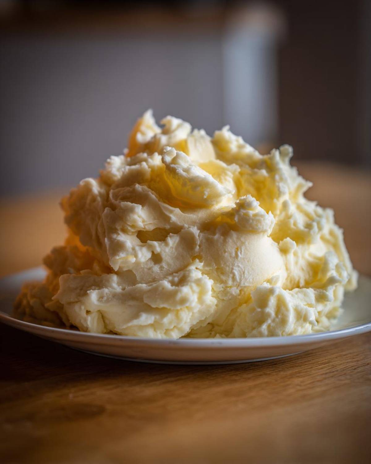 A generous mound of creamy, fluffy Boursin mashed potatoes served on a white plate.