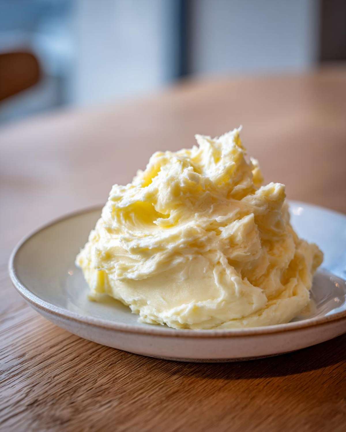 A generous mound of fluffy, creamy Boursin mashed potatoes served on a light-colored plate.