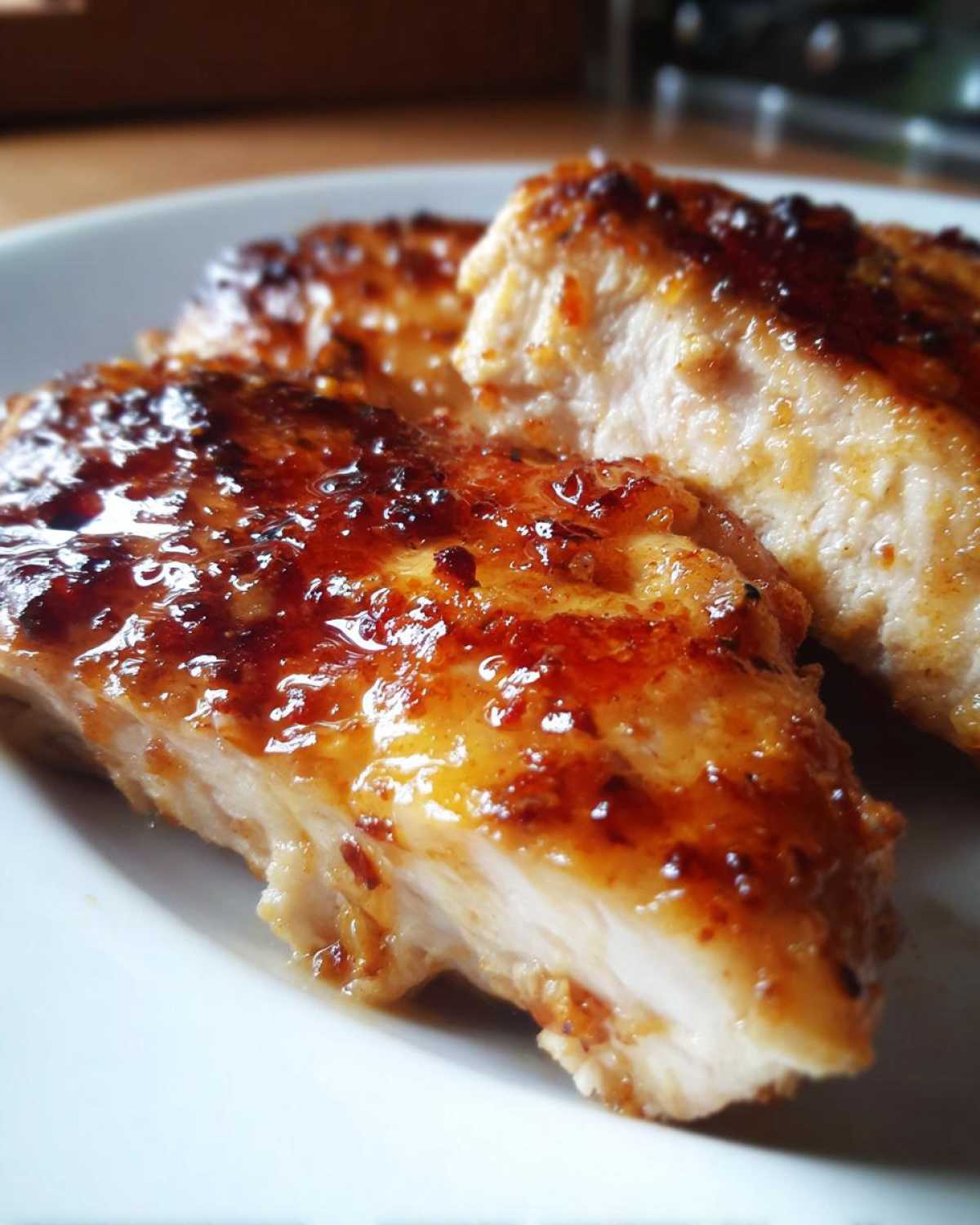 Close-up of juicy chicken breast pieces coated in a shiny, caramelized glaze from the chicken marinade.