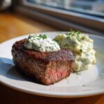 Perfectly cooked steak topped with a dollop of creamy horseradish sauce and served with mashed potatoes.