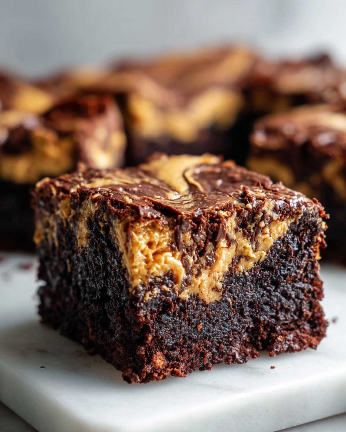 A rich, fudgy square of Gluten-Free Chocolate Peanut Butter Swirl Brownies featuring a distinct peanut butter swirl on top.