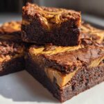 Close-up of stacked, fudgy Gluten-Free Chocolate Peanut Butter Swirl Brownies with rich swirls on top.