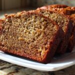 Close-up of three moist slices of banana bread step by step displayed on a white platter.