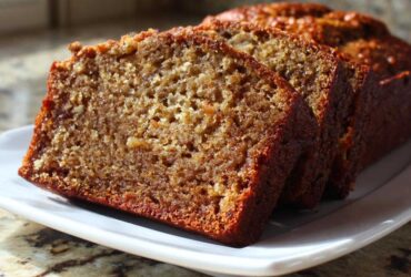Close-up of three moist slices of banana bread step by step displayed on a white platter.