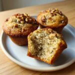 Close-up of three Banana Walnut Cottage Cheese Muffin Breakfasts, one cut open to show the moist interior texture.