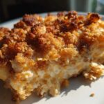 Close-up of a serving of Cozy Creamy Vegetable Casserole Bake with a golden, crunchy topping.