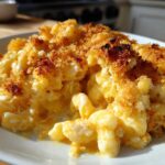 A close-up serving of creamy, cheesy Baked Mac and Cheese topped with a golden, crispy breadcrumb crust.