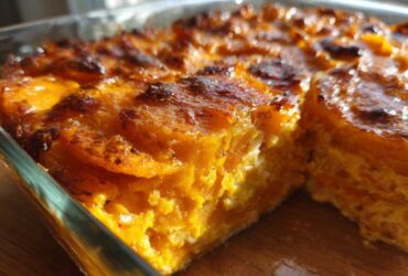 Close-up of baked Brown Sugar Glazed Scalloped Sweet Potatoes with a caramelized, slightly charred top.