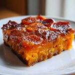 Close-up of a square serving of Brown Sugar Glazed Scalloped Sweet Potatoes with a rich, shiny amber glaze.